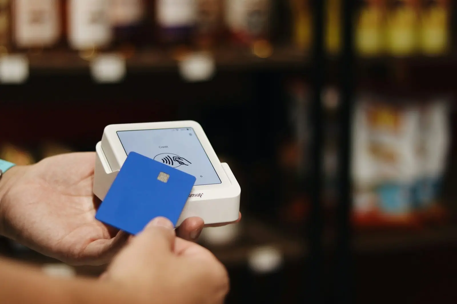 A person holding a blue and white box in their hand